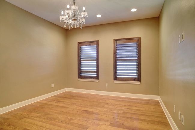 Upstairs Bedroom which has a huge closet and private bathroom. This could be considered a second Primary Bed/Bath. Must see the closet and hidden room behind the bookcase. | Image 21