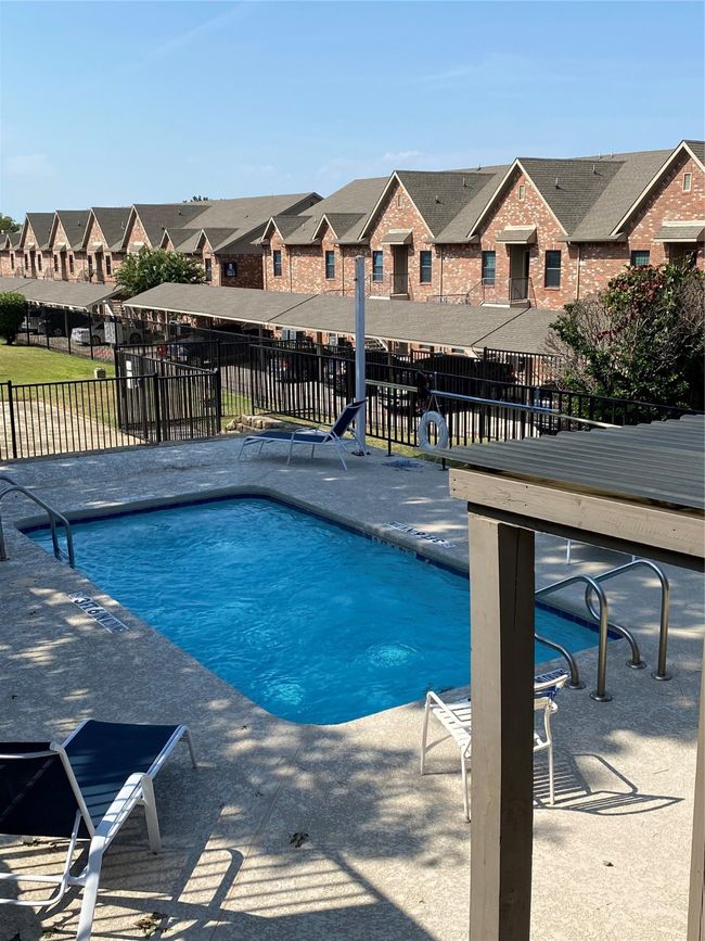 Community pool with a residential view and a patio | Image 27