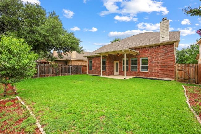 Back of house with a patio area, a fully fenced backyard, flat and landscaped | Image 31