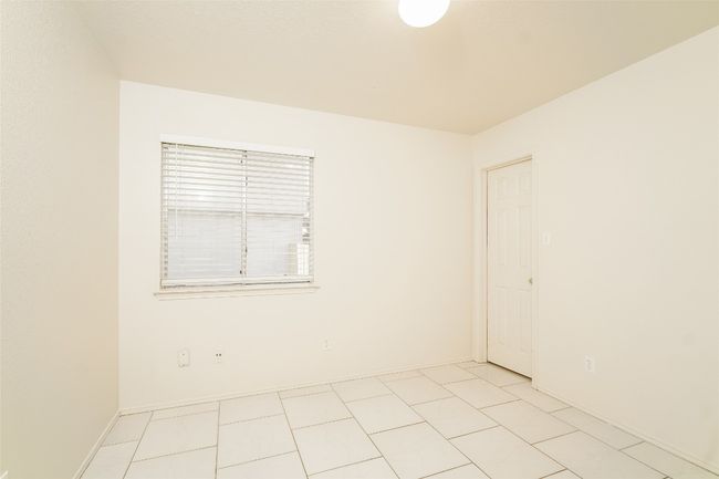 Spare room featuring light tile patterned floors and baseboards | Image 15