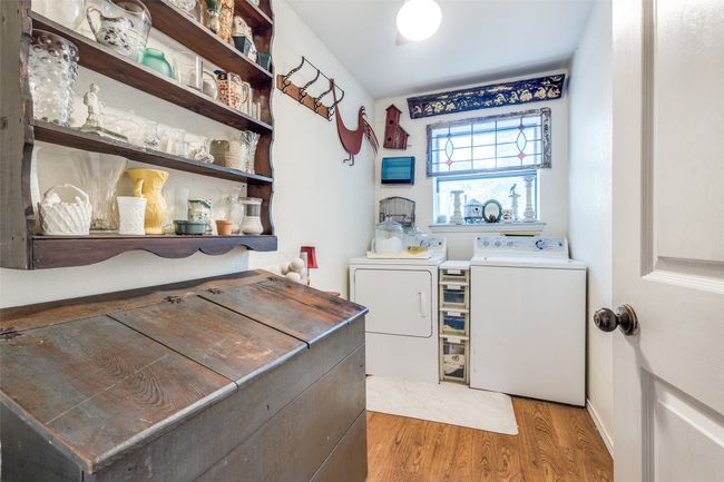 Laundry room featuring light wood-style floors and washing machine and clothes dryer | Image 26