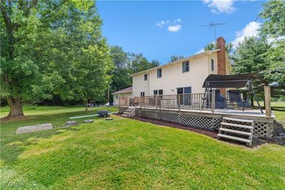 Rear view of property featuring a lawn and a deck | Image 3