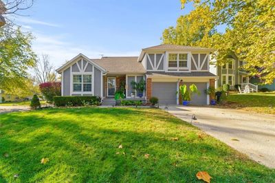 View of front of property with a garage and a front yard | Image 1