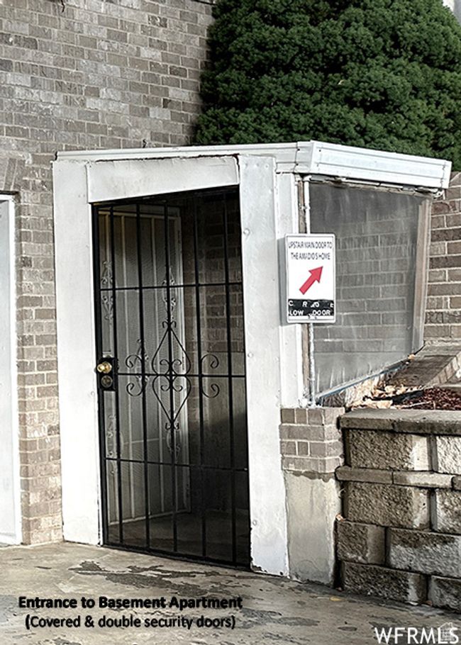 View of exterior entry featuring brick siding | Image 67