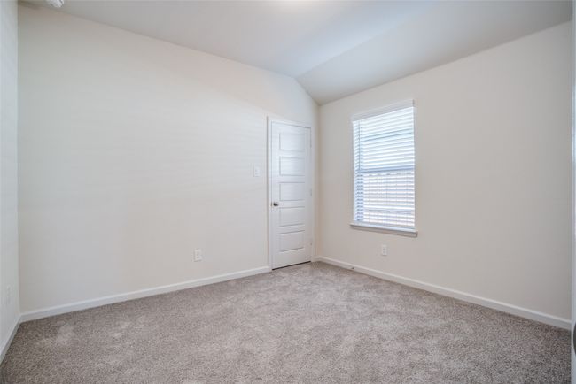 Empty room featuring light colored carpet, baseboards, and lofted ceiling | Image 20