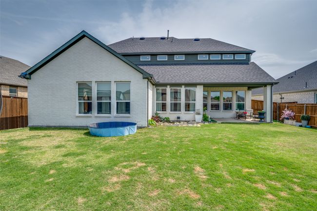 Back of house with a lawn, roof with shingles, a patio area, fence, and brick siding | Image 34