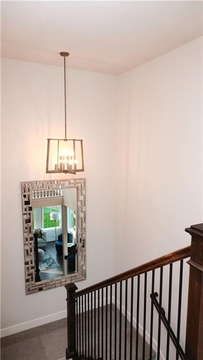 Stairway with a chandelier, carpet flooring, and baseboards | Image 26