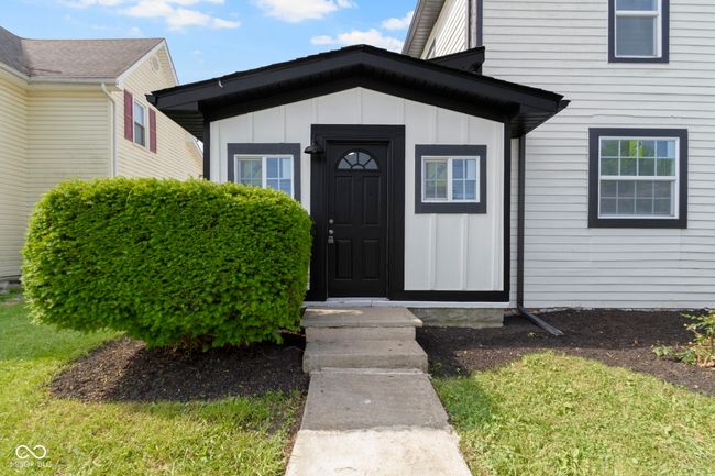 view of exterior entry with board and batten siding | Image 4