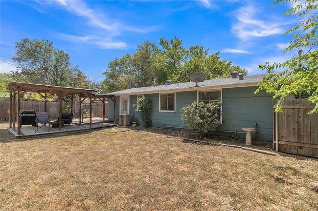 Rear view of house featuring a fenced backyard, a gazebo, and a deck | Image 14