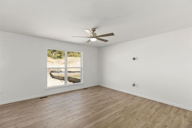 Empty room featuring ceiling fan and light hardwood / wood-style floors | Image 19