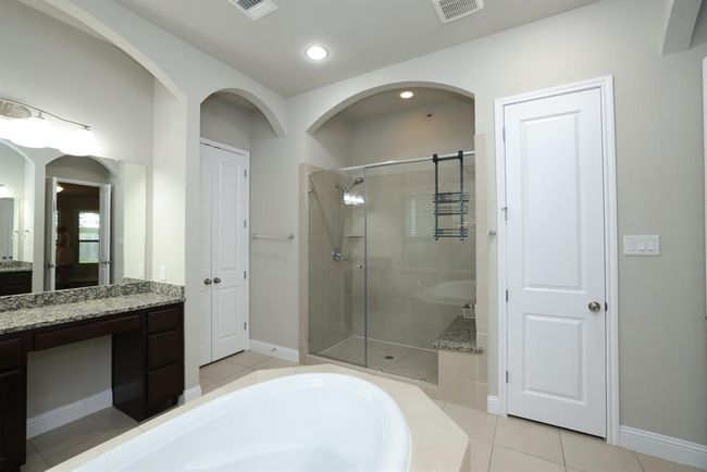 Oversized shower with seat. Next door is water closet. | Image 33