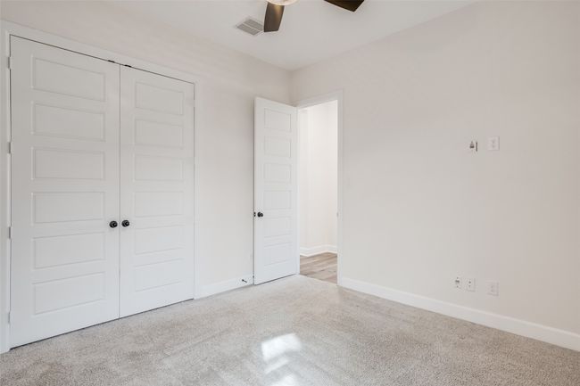 Unfurnished bedroom featuring carpet, a closet, and ceiling fan | Image 8
