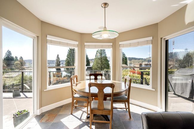 Dining area featuring stone tile floors and baseboards | Image 13