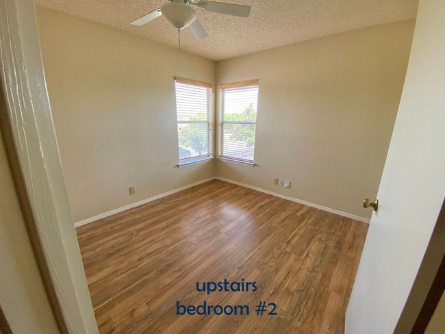 Bedroom with vinyl floors, ceiling fan | Image 14