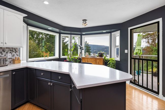 kitchen with eating nook and door to deck | Image 6