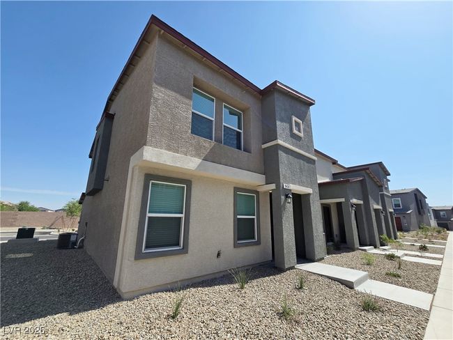 View of front of property with stucco siding and central AC | Image 33