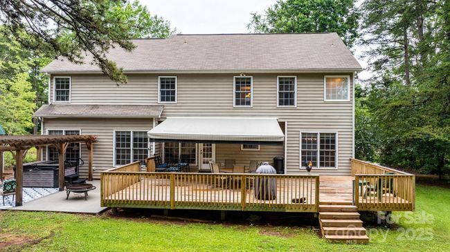 Outside is this expansive back deck and patio area - accessed from the kitchen. | Image 31