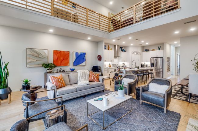 Living room featuring visible vents, light wood finished floors, baseboards, a towering ceiling, and recessed lighting | Image 6