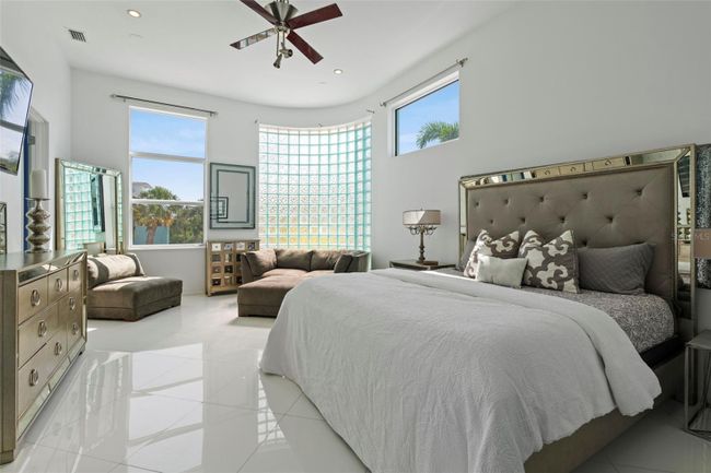 Relax in the private owner's suite bathed in light through the glass block wall feature. | Image 14