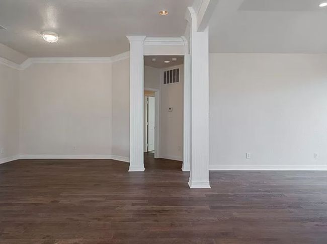 Additional living space featuring dark wood finished floors and recessed lighting | Image 4
