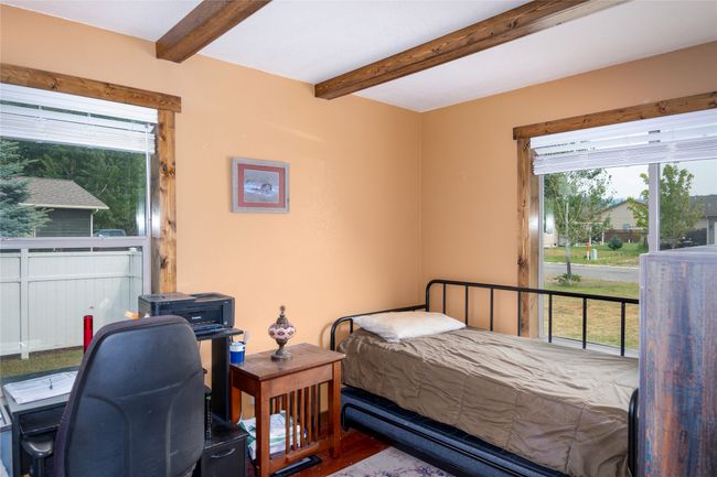 Bedroom with beam ceiling and wood finished floors | Image 47
