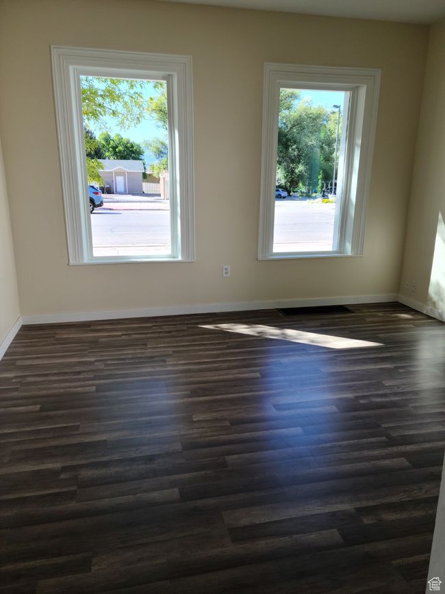 Unfurnished room with dark wood-type flooring and baseboards | Image 18