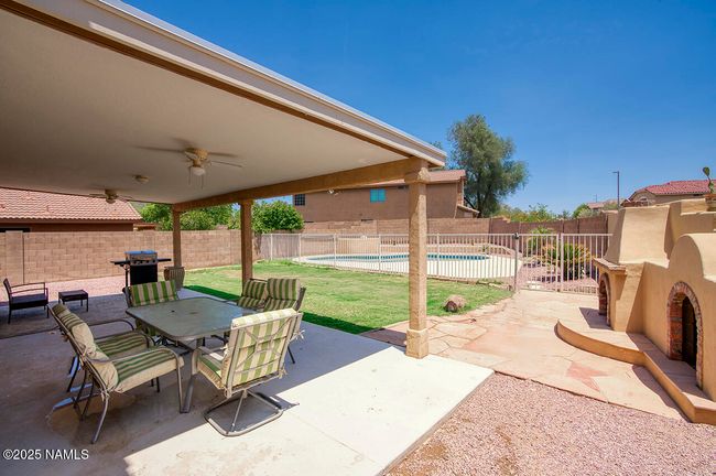 Entertaining backyard with wood fireplace and gated pool | Image 23