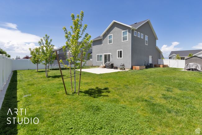 Back of house with a trampoline, a patio, stucco siding, and cooling unit | Image 30