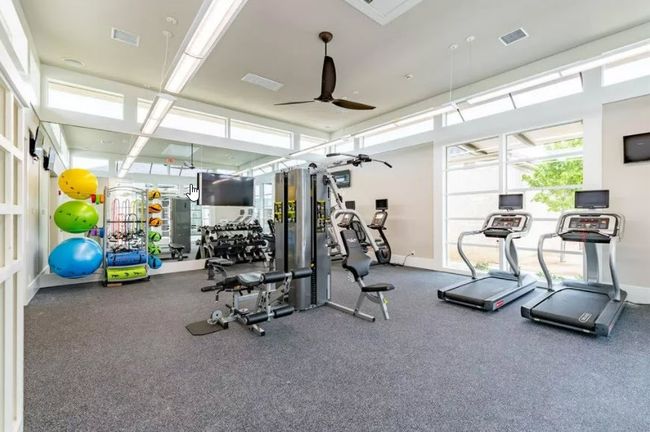 Workout area with visible vents, baseboards, and ceiling fan | Image 16