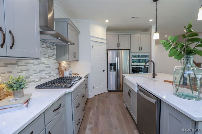 Kitchen with granite countertops, gas cooking, island, pantry, stainless steel appliances and LED recessed lighting. | Image 4