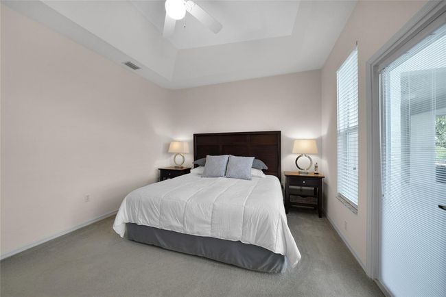 PRIMARY BEDROOM EN-SUITE WITH DOORWAY TO POOL AND LANAI | Image 28