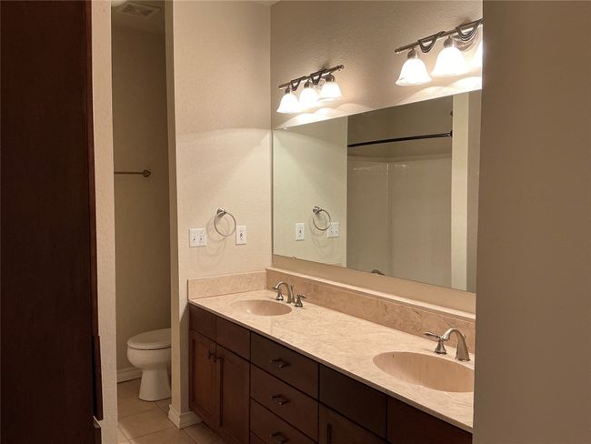 Full bathroom with tile patterned flooring, a textured wall, and a sink | Image 16