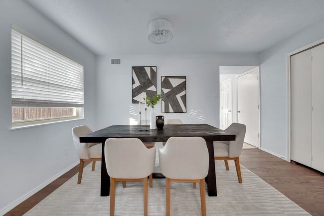 Dining area with wood finished floors and baseboards | Image 8