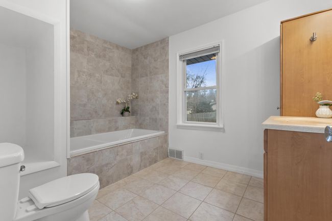 Private Full Bathroom includes a jetted tub , vanity cabinet w/ addtional linen and open niche ready for creative storage | Image 17