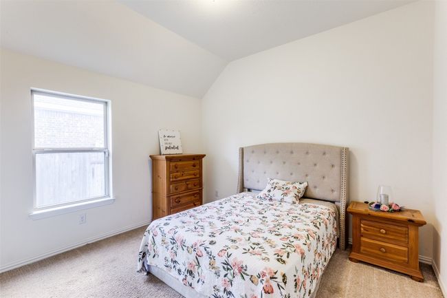 Carpeted bedroom with lofted ceiling and baseboards | Image 19