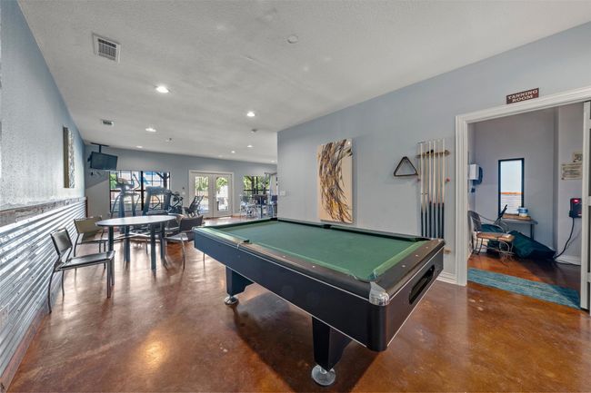 Recreation room with finished concrete flooring, french doors, pool table, and recessed lighting | Image 19