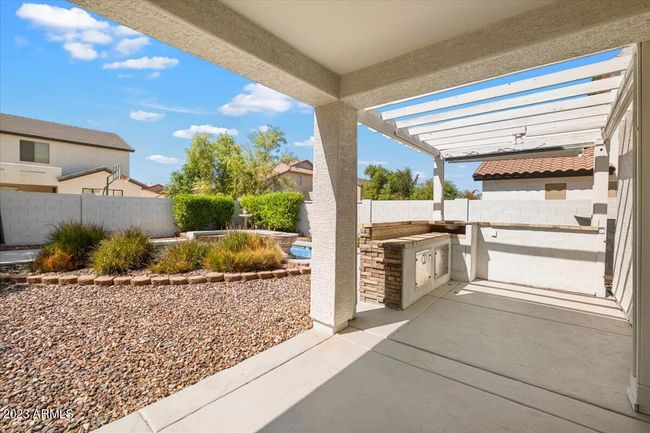 Covered patio with room for a BBQ, table, seating or more | Image 24