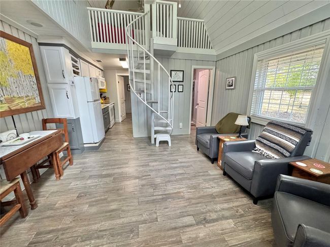 Living room with spiral stairs to loft bedroom | Image 6