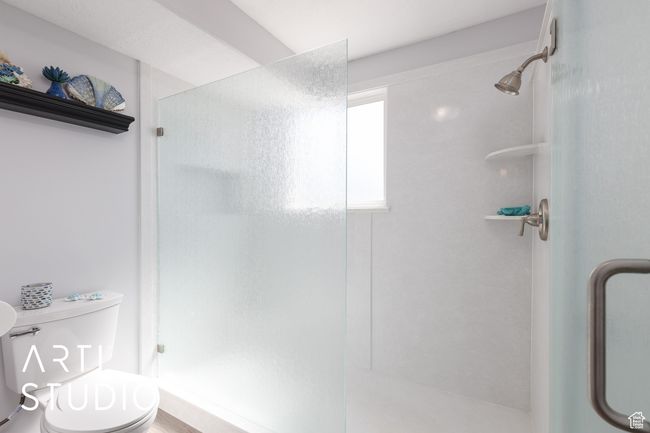 Full bath featuring a shower stall and toilet | Image 24