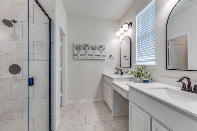 Bathroom with a stall shower, two vanities, and tile patterned floors | Image 17