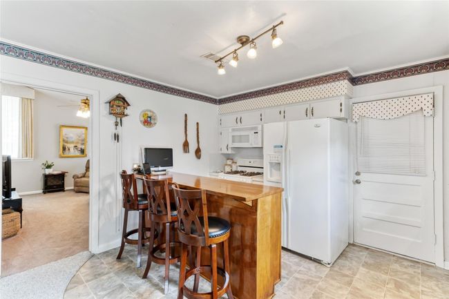 Offering great connectivity to the living room, the kitchen also features a walk-through door on the right providing direct access to the attached 1-car garage. | Image 8