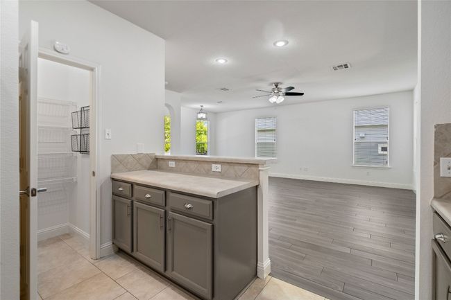 Kitchen Overlooks Living and Dining Areas | Image 11