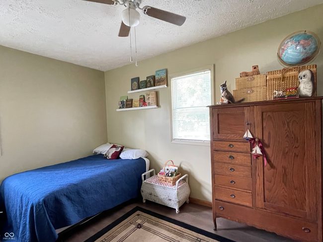 bedroom with a textured ceiling and a ceiling fan | Image 8