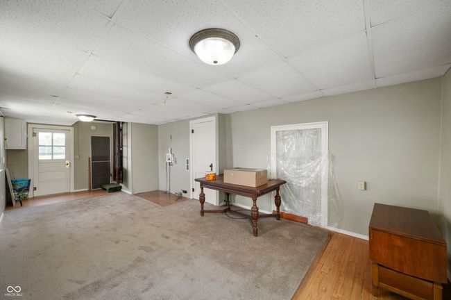 basement with a paneled ceiling and light wood-style floors | Image 10