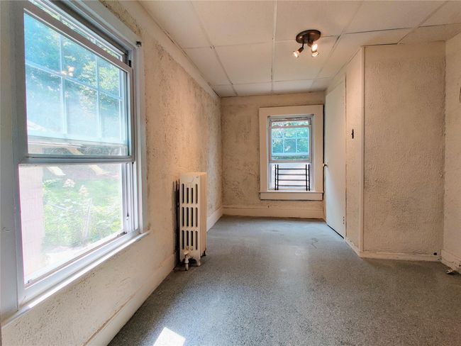 Full bathroom featuring tile patterned flooring, tile walls, toilet, and shower / bathtub combination with curtain | Image 19