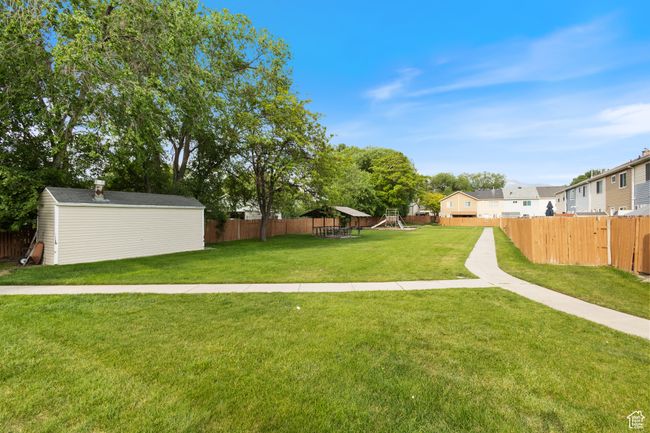 View of yard with a shed and a playground | Image 21