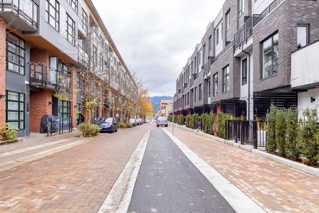 View of street featuring sidewalks, curbs, and street lighting | Image 6
