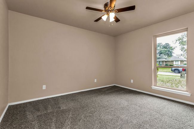 Carpeted empty room featuring baseboards and ceiling fan | Image 21