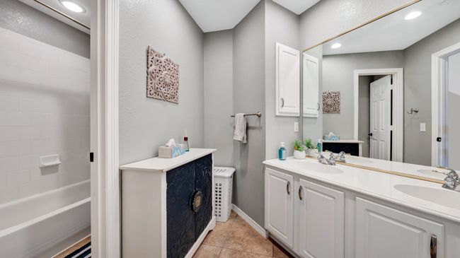 Full bathroom featuring tub and toilet area, recessed lighting, double sink vanity, and tile floors | Image 37
