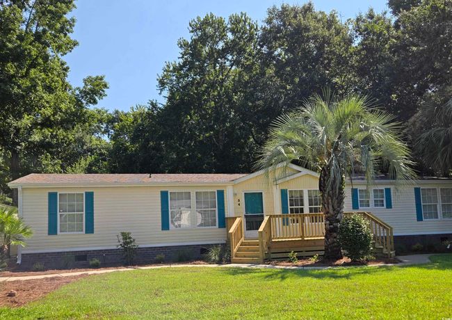 Manufactured / mobile home featuring crawl space, a wooden deck, and a front lawn | Image 5